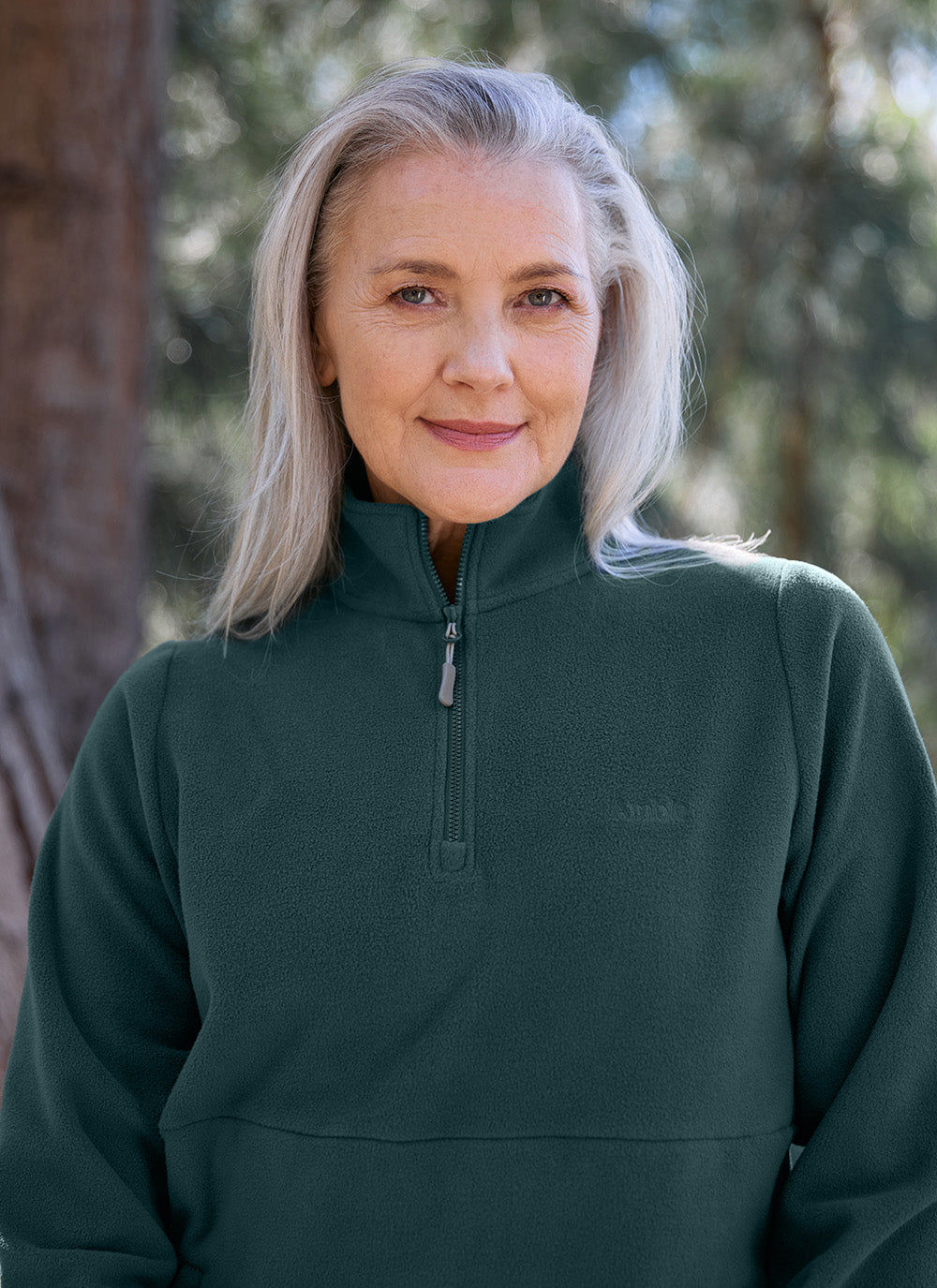 Older woman wearing the Sugarloaf Fleece in Pine Green